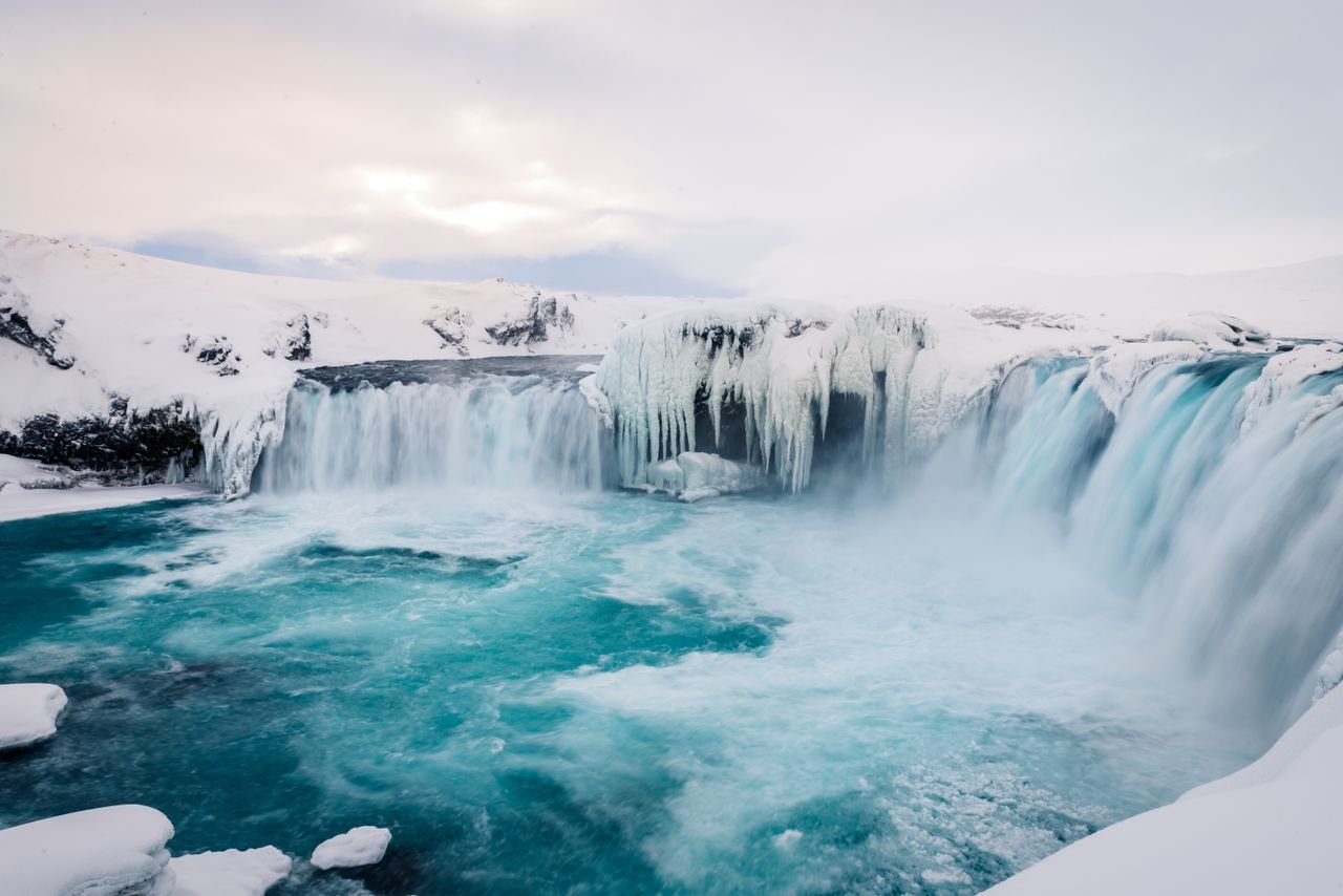 The Art of Drawing Readers In: Your attractive post title goes here Breathtaking winter view of a frozen waterfall in Icelands snowy wilderness.