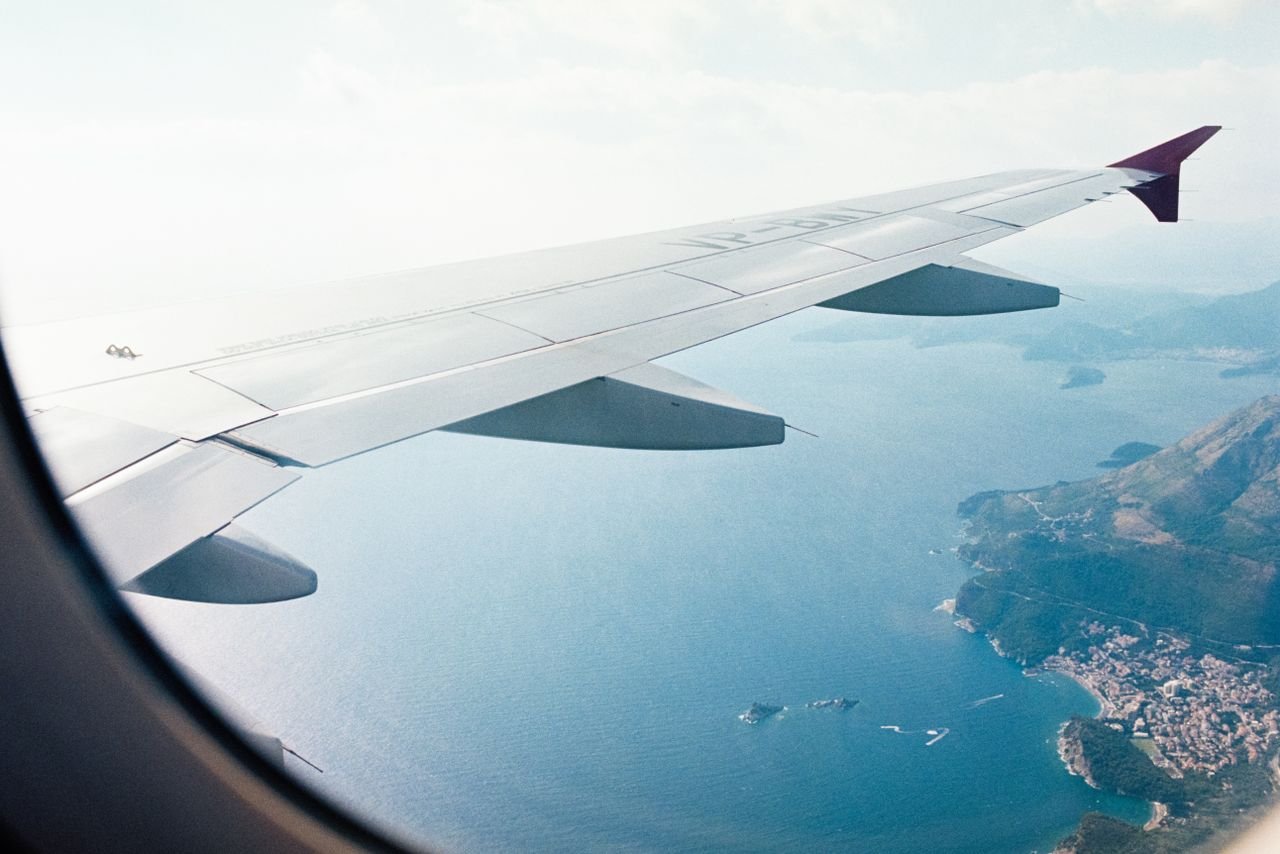 Crafting Captivating Headlines: Your awesome post title goes here Aerial view from an airplane window of a scenic Mediterranean coastline.